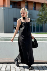 a lady in a black square neck dress made of xiangyun silk